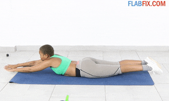 Woman performing arm haulers exercise on floor