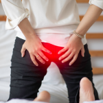 person experiencing hemorrhoids discomfort while sitting | he can try the best hemorrhoids supplements