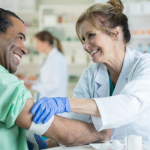 senior adult receiving flu vaccine at clinic with healthcare professional | senior flu shot side effects
