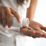 a woman taking luteolin supplement with water at home | luteolin supplement side effects