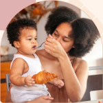 A mother in Chicago researching side effects of feeding baby food too early for a healthy lifestyle.