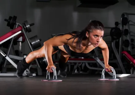 Woman performing regular push ups at home workout -