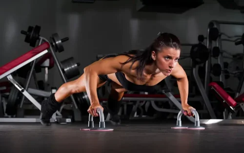 Blog 52 Woman performing regular push ups at home workout -