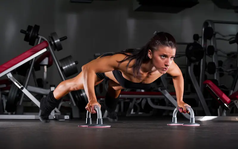 Woman performing regular push ups at home workout -